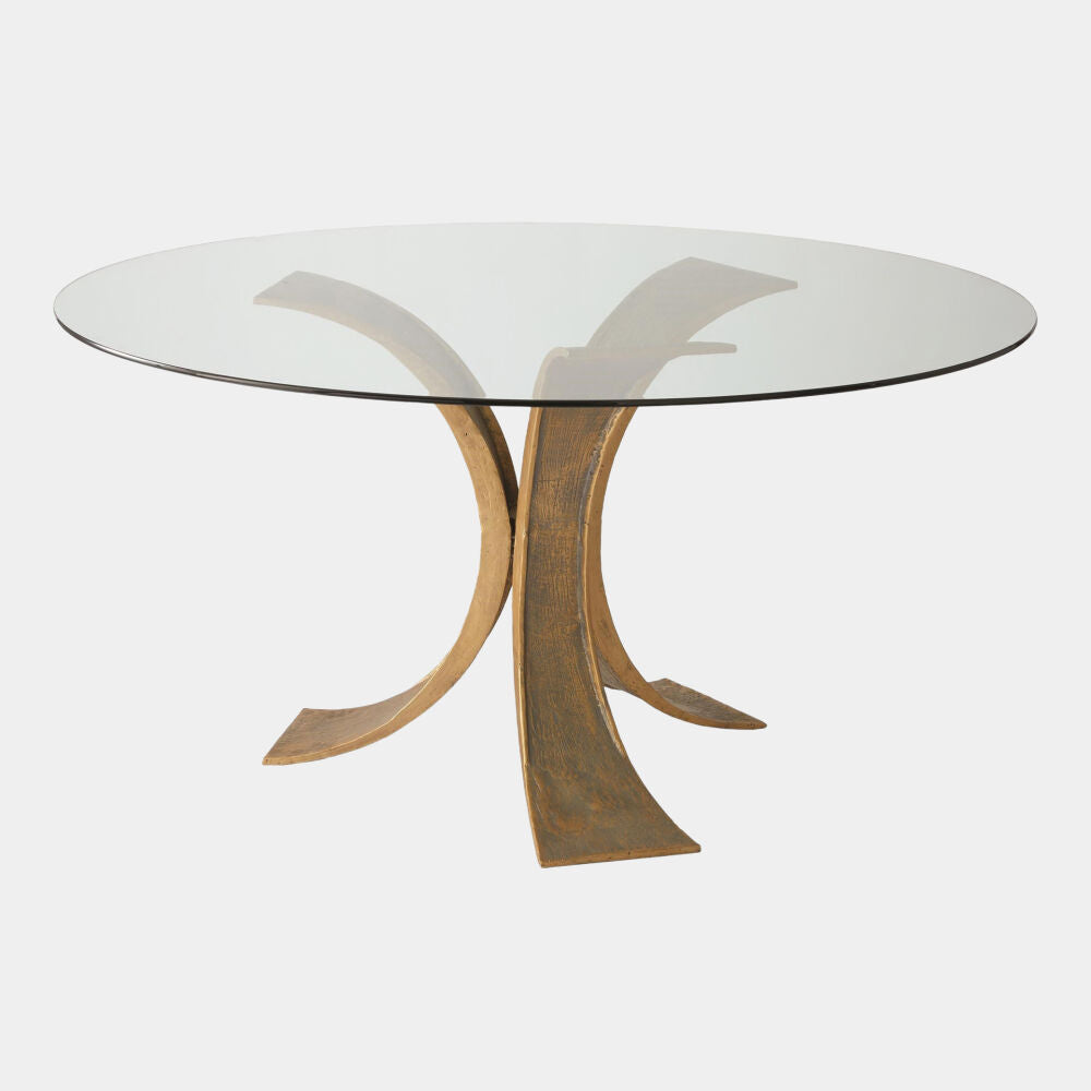 Glass dining table with bronze metal legs on a white background