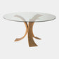 Glass dining table with a unique metal base on a white background