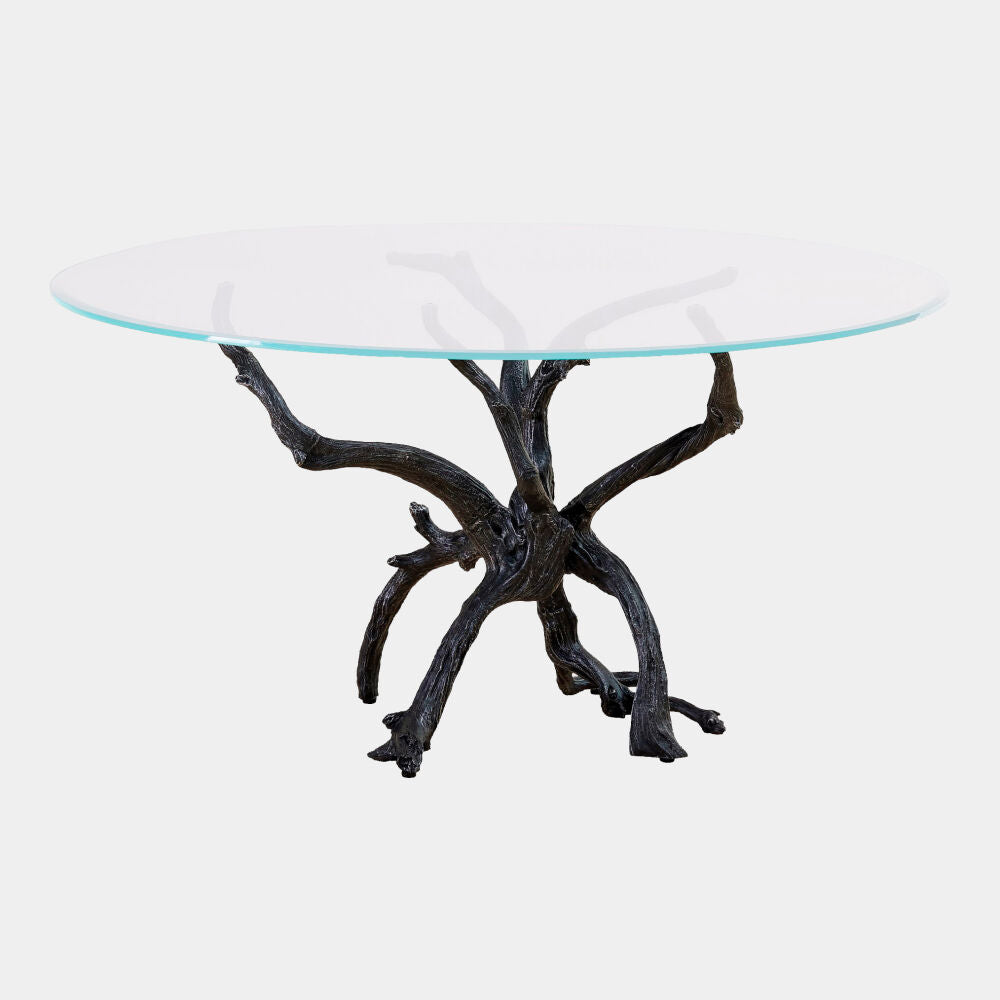 Glass top table with a natural branch base on a white background