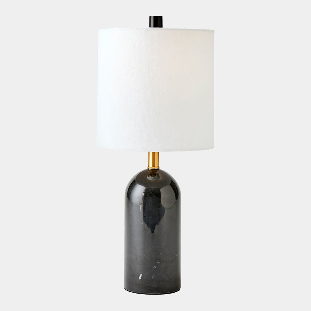 Table lamp with black base and white shade on a light gray background