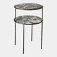 A two-tier nesting side table with round marble-patterned tops in gray, black, and white, supported by a twisted black metal frame and legs, shown on a light gray background.