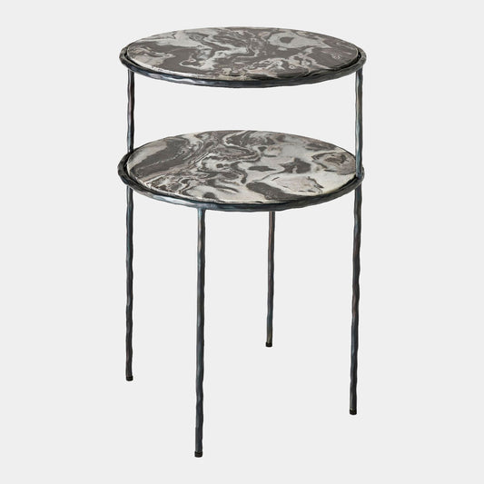 A two-tier nesting side table with round marble-patterned tops in gray, black, and white, supported by a twisted black metal frame and legs, shown on a light gray background.