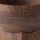 Close-up of a dark brown wooden bowl showing the rich wood grain texture and curved rim.