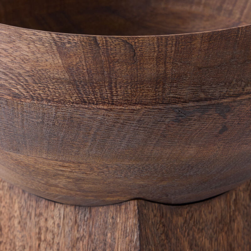 Close-up of a dark brown wooden bowl showing the rich wood grain texture and curved rim.