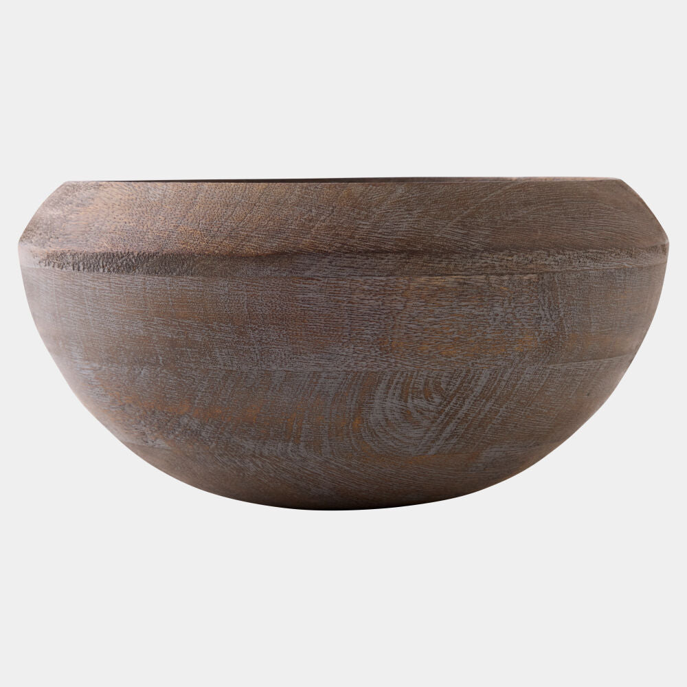 A rustic wooden bowl with a wide rim and a textured, weathered finish, shown against a plain light gray background.