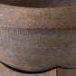 Close-up detail of a dark brown wooden bowl showing the natural wood grain texture and smooth curved rim.