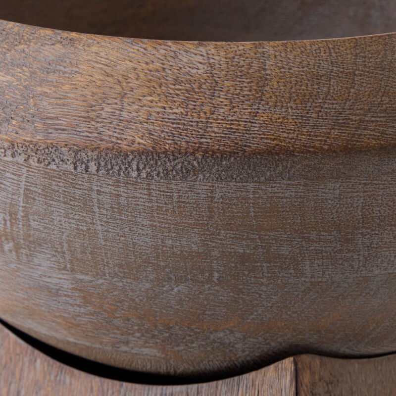 Close-up detail of a dark brown wooden bowl showing the natural wood grain texture and smooth curved rim.