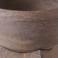 Close-up of a rustic wooden bowl showing the detailed wood grain texture and natural brown color.