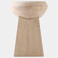 A minimalist wooden stool with a rounded bowl-shaped seat and a tapered rectangular pedestal base, crafted from light natural wood with visible grain.