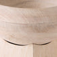 Close-up of a light natural wood bowl showing the grain texture and curved rim.