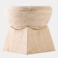 A light natural wood pedestal stool with a rounded seat and a geometric, tiered base, shown against a plain light gray background.
