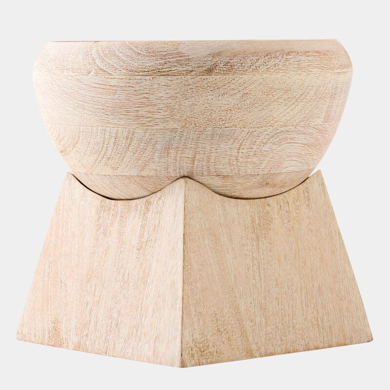 A light natural wood pedestal stool with a rounded seat and a geometric, tiered base, shown against a plain light gray background.
