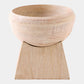 Wooden bowl on a wooden stand with a light background