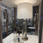 Decorative lamp with a white shade on a table in an indoor setting