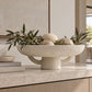 Marie Mache Bowl styled on console table with decorative balls and branches inside of it 