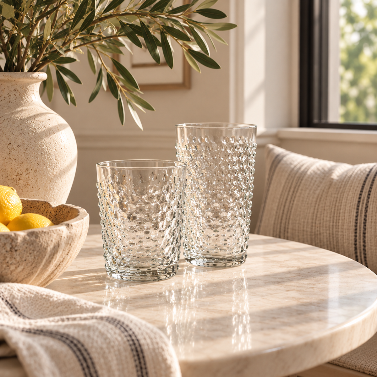 clear glass drinkware styled on a kitchen nook table