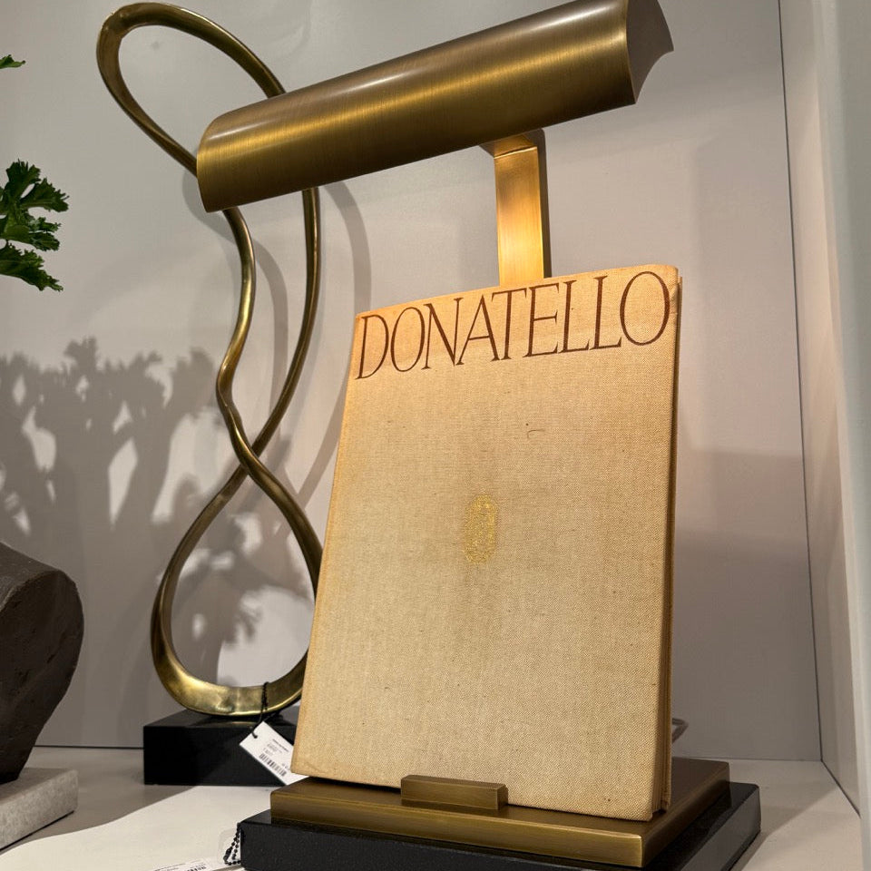 Decorative lamp with 'DONATELLO' branding on a shelf.