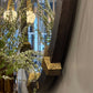 Decorative letter 'L' with gold texture in front of a mirror reflecting interior decor.