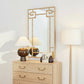 Wooden dresser with decorative mirror and lamps in a room setting