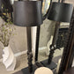 Black floor lamp with decorative elements in a room setting