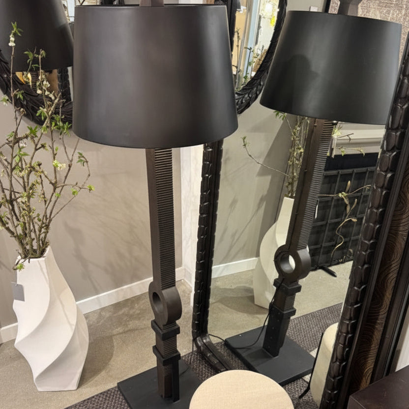 Black floor lamp with decorative elements in a room setting