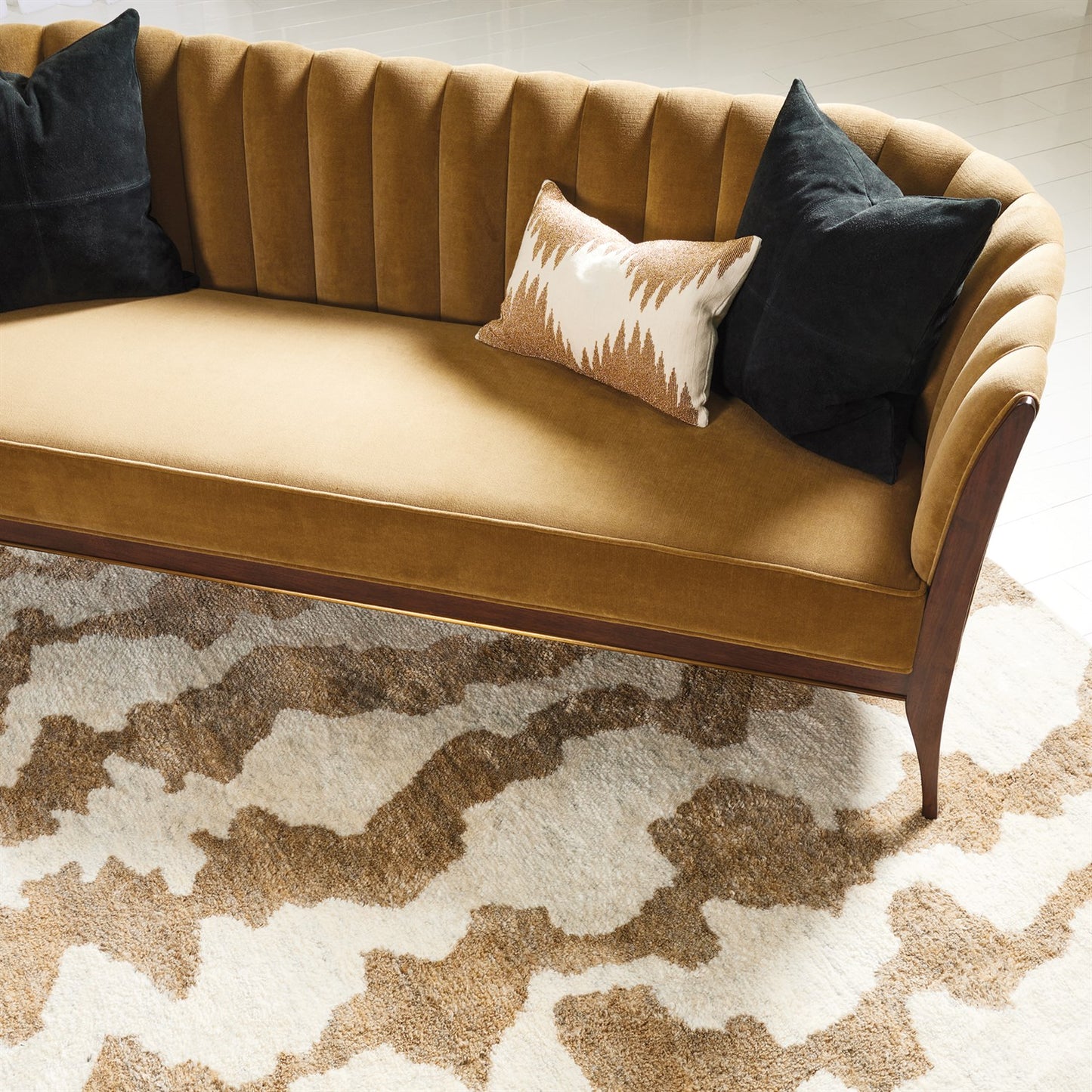 Brown sofa with decorative pillows on a patterned rug