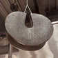 Textured round object hanging from a ceiling
