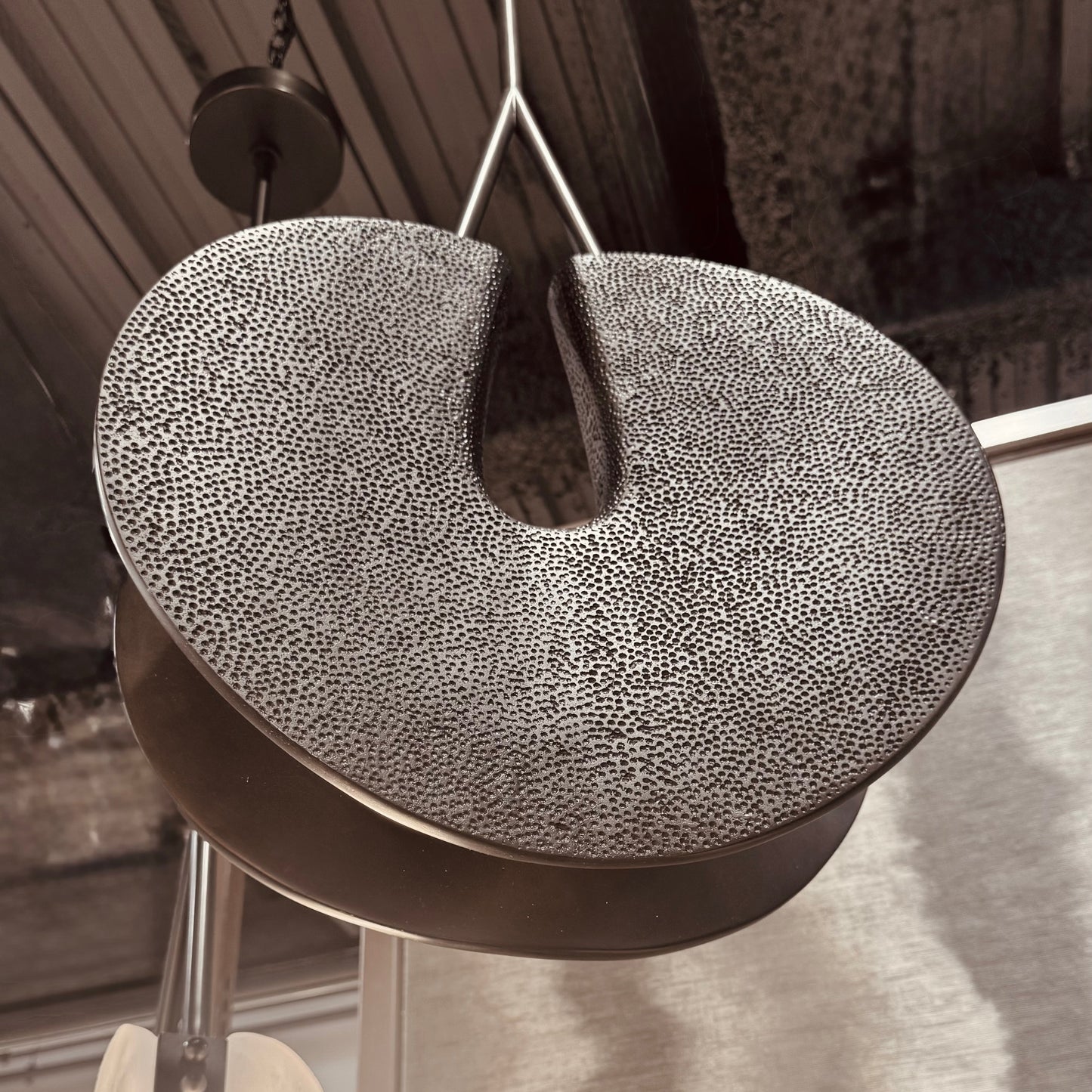 Textured round object hanging from a ceiling