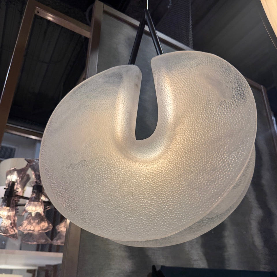 Decorative light fixture with textured surface hanging indoors