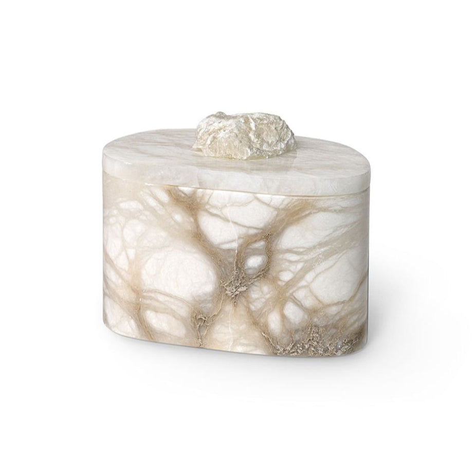A small cylindrical box with a lid, crafted from polished onyx or marble featuring cream, beige, and light brown veining, topped with a rough, natural stone knob, set against a plain white background.
