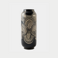 Black vase with geometric pattern on a white background