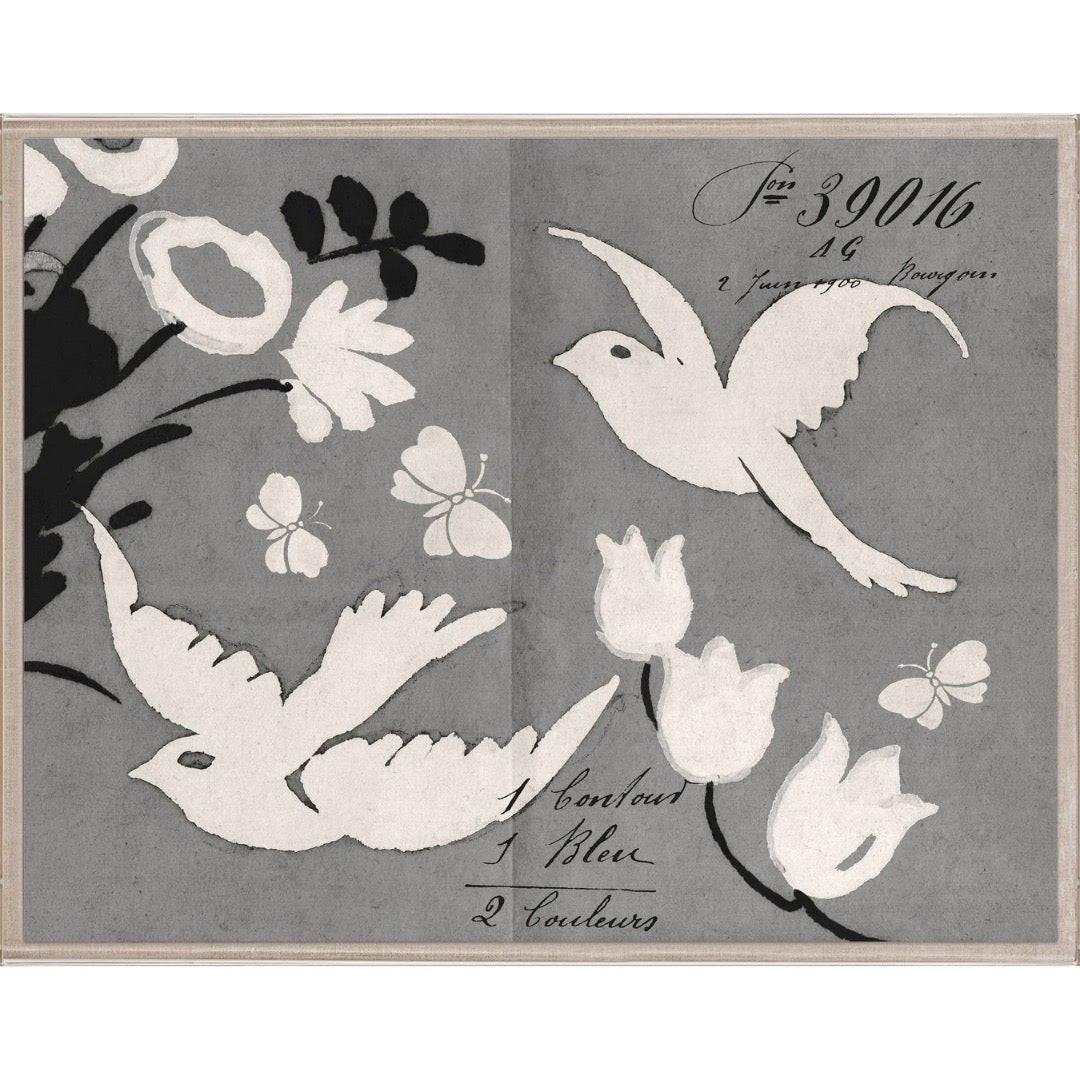Decorative paper cutout of birds and flowers on a gray background with cursive text.