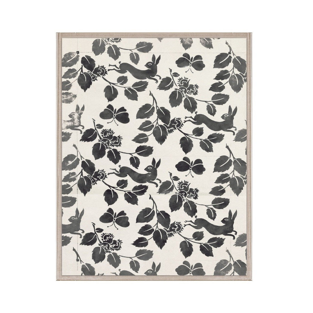 Framed artwork with black floral and animal pattern on a white background