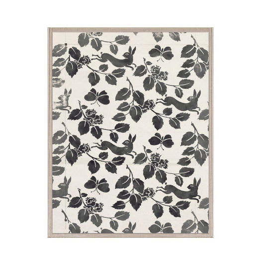 Framed artwork with black floral and animal pattern on a white background