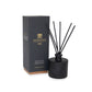 Black diffuser with reeds and packaging on a white background