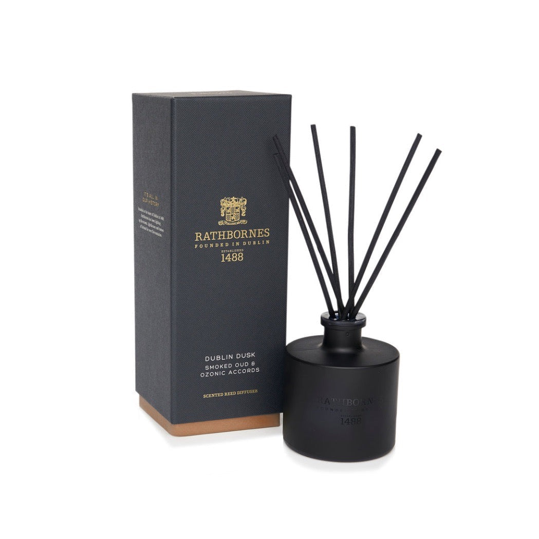 Black diffuser with reeds and packaging on a white background