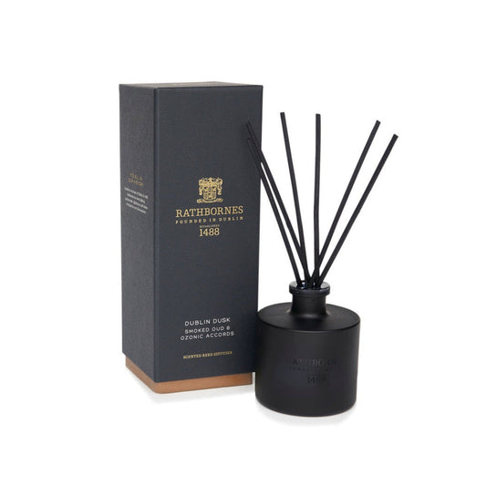 Black diffuser with reeds and packaging on a white background