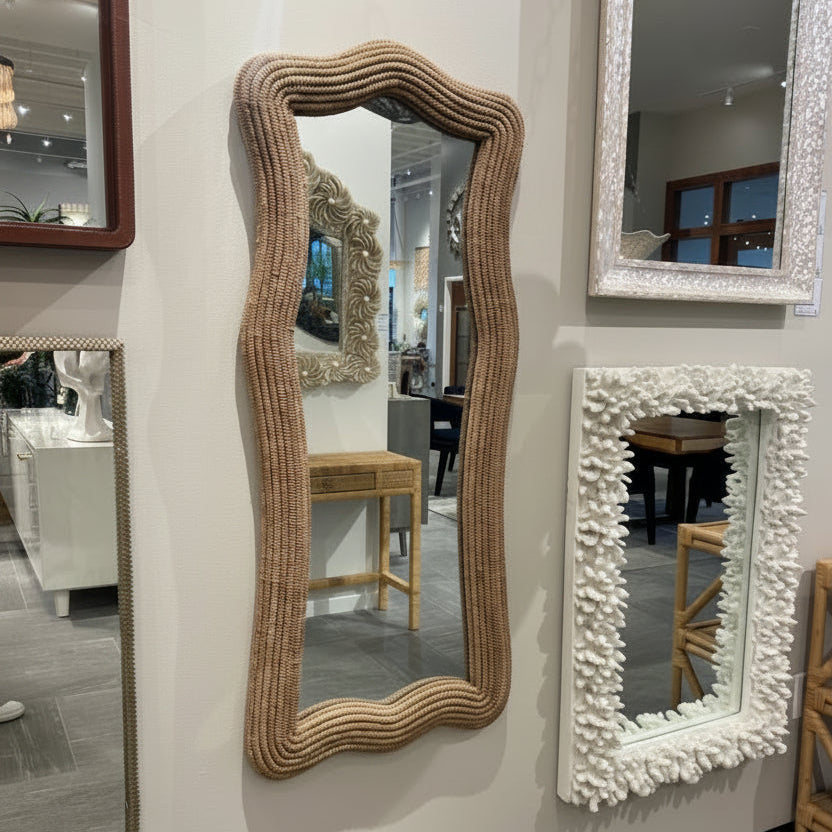 Various decorative mirrors with unique frames on a wall.
