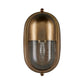 A wall-mounted light fixture with an oval, dome-shaped brass-toned metal body and a ribbed clear glass shade, shown against a plain white background.