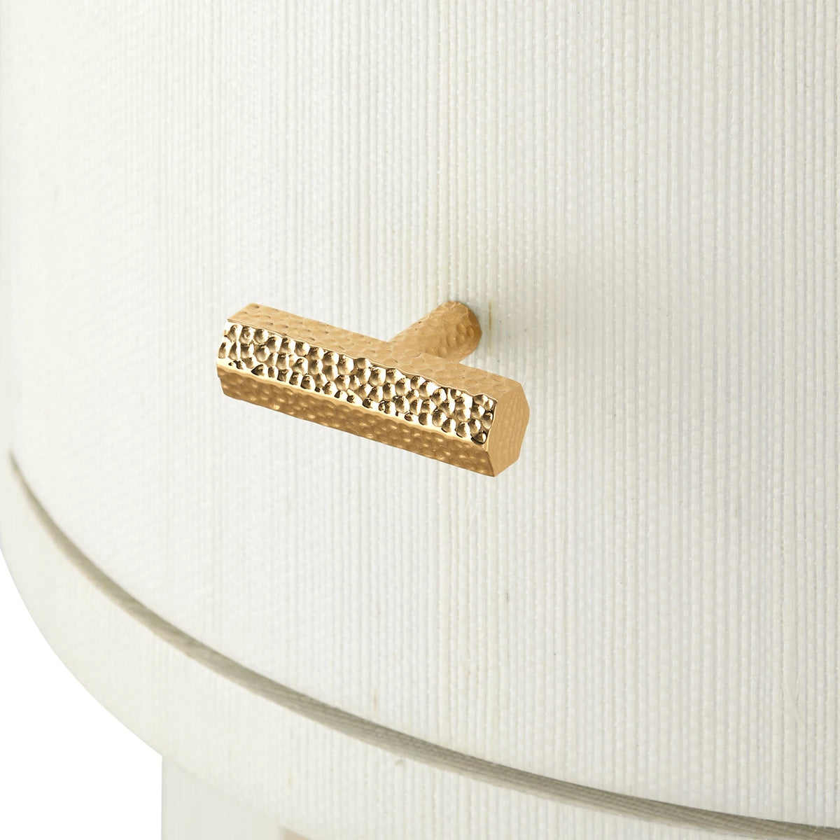 Gold textured handle on a white surface