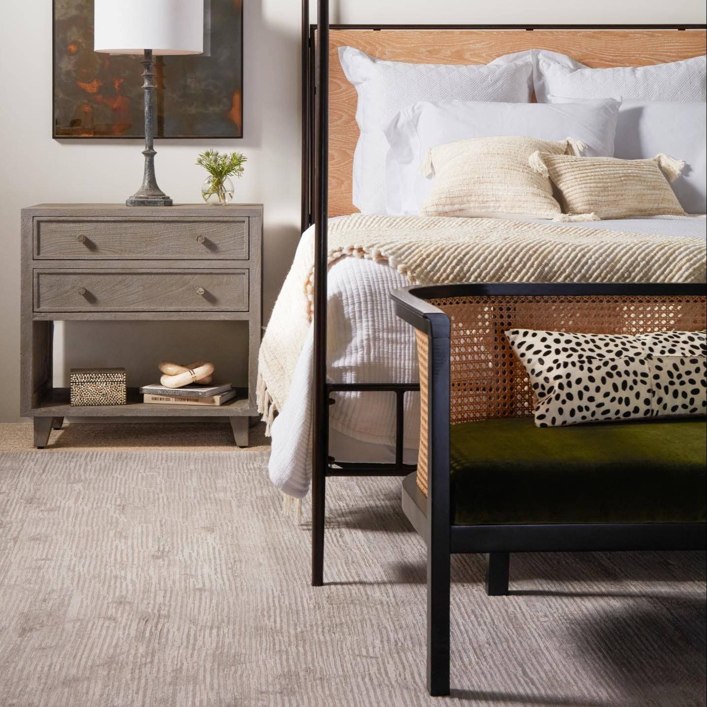 Bedroom with a bed and nightstand featuring decorative items.