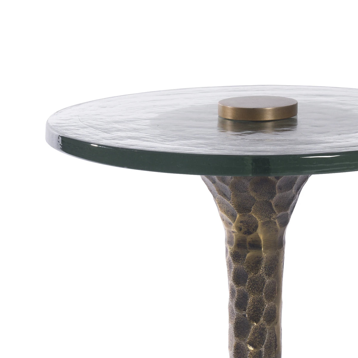 Round glass table with textured bronze base on a white background