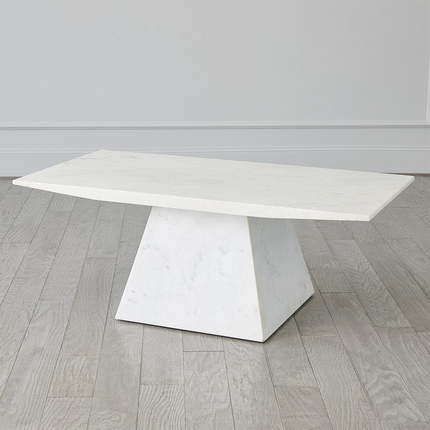 White marble dining table on a wooden floor with a neutral background