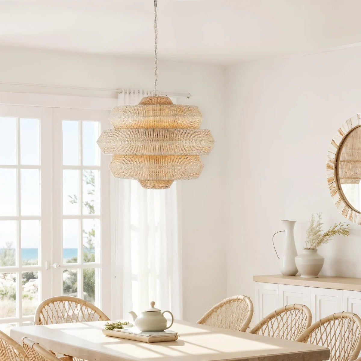 Dining room with wooden table and chairs, wicker pendant light, and window view.