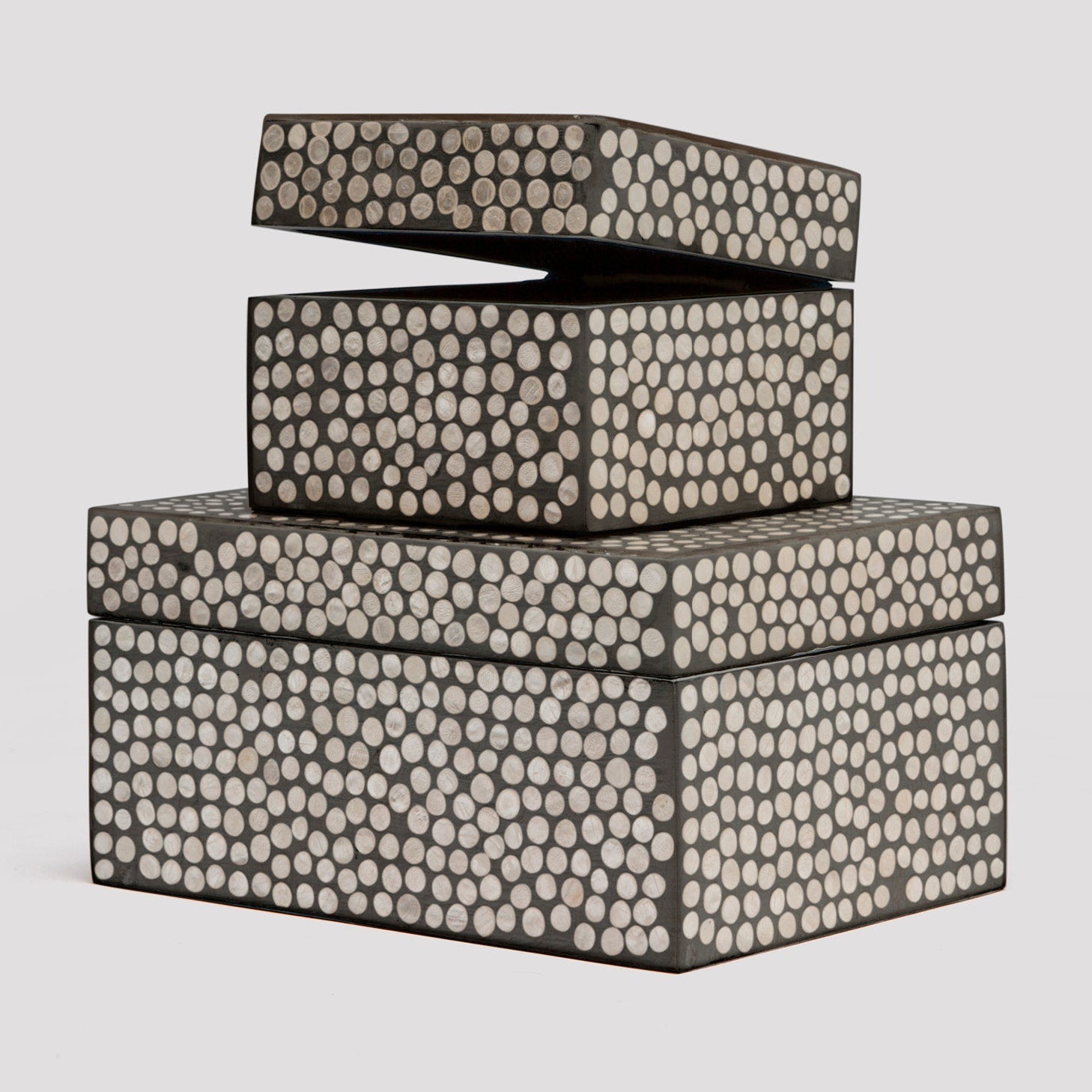 Set of three decorative boxes with a patterned design on a light gray background
