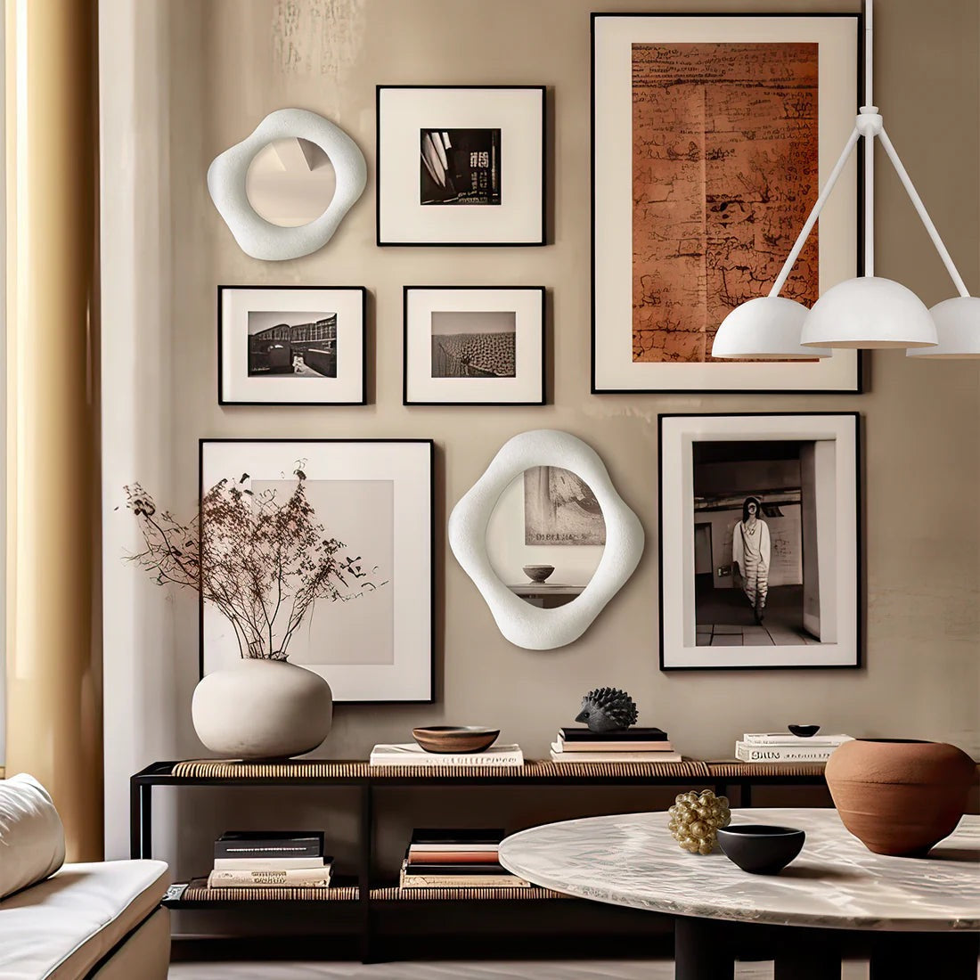 Living room with wall art, mirrors, and decor items on a beige wall.