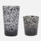 Two black and white patterned glass tumblers on a white background