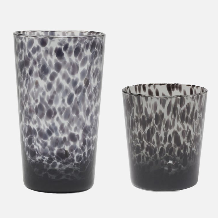 Two black and white patterned glass tumblers on a white background