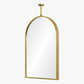 Gold-framed arch mirror on a white background