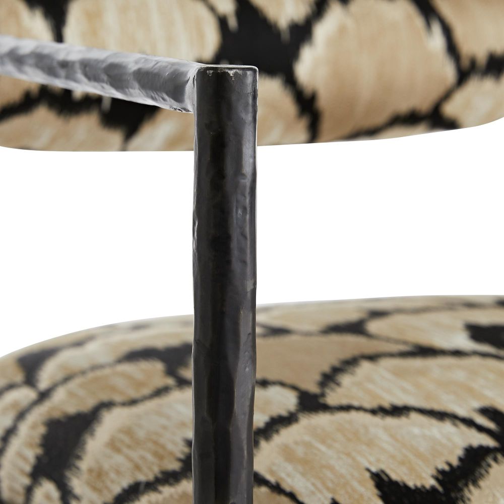 Close-up of a chair leg with patterned fabric background